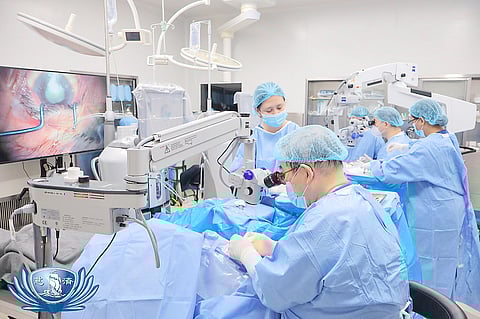 DR. Antonio Say (foreground) removes a patient’s cataract using a phacoemulsification system. 