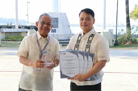 Subic Bay Metropolitan Authority (SBMA) Chairman and Administrator Eduardo Jose L. Aliño proudly holds the trophy and several Certificates of Recognition for its performance in the 2024 Quarterly Survey of Philippine Business and Industry with Norman L. Bundalian, Chief Statistical Specialist of the Philippine Statistics Authority (PSA)-Zambales and PSA personnel during the flag ceremony in front of the Administration Building 229 on January 19, 2026. 