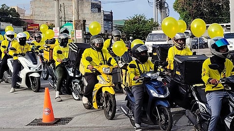 DRIVER-partners from Maxim ride in formation along Batangas City streets during the Batangas City Fiesta 2026 parade, with motorcycles decorated in yellow and carrying balloons as part of the procession.