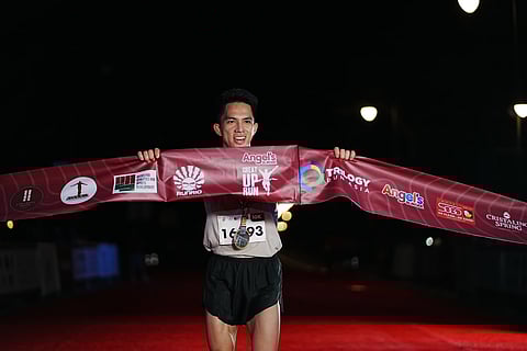 ROY Laudit celebrates after crossing the finish line to rule the men's 10K event of The Great UP Run on Sunday at the University of the Philippines Diliman Grounds over the weekend. 
