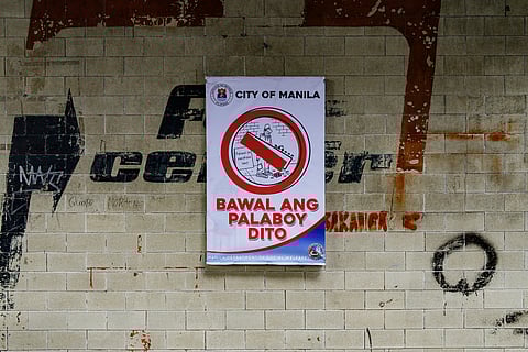 A homeless man drinks from a bottled water he picked up from a trash bin outside the LRT-1 Carriedo station in Manila on Tuesday, 27 January 2026.

Manila Mayor Isko Moreno has faced criticism from rights advocates who describe his policies as "anti-poor," including the placement of signs in the city that say, “Bawal ang palaboy dito."