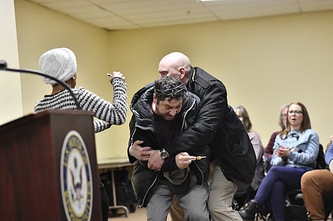 A MAN is tackled after spraying an unknown substance at United States Democratic Representative Ilhan Omar (left) during a town hall she was hosting in Minneapolis, Minnesota, on 27 January 2026. 