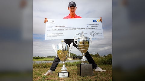 MICAH Shin shows off the big P2.2-million check and trophies he collected after winning his second The Country Club Invitational in Laguna on Friday.