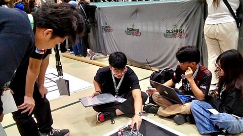 CAVITE National High School students prepare for the BoxBot Auto competition. Their robot is placed under the three kilogram weight category.