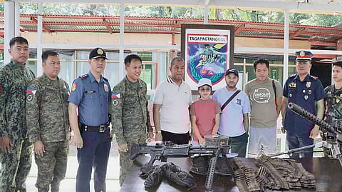 THE former rebels show the firearms and explosives that they surrendered to authorities in Camarines Norte.