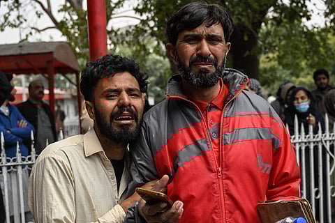 People mourn the death of their relatives following a suicide bombing at a Shiite mosque, outside a hospital in Islamabad on 6 February 2026. 