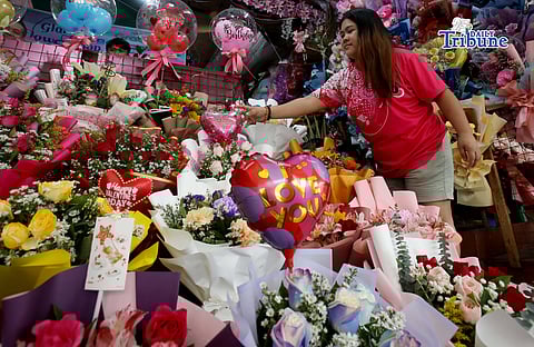 Personnel prepare flower bouquets for sale at a flower shop in Araneta City, Cubao, Quezon City, on Saturday, 7 February 2026, as Valentine’s Day approaches and demand for bouquets rises, with flowers among the most popular gifts for the occasion
