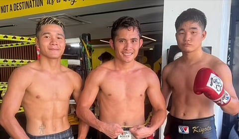 WBC champion Melvin Jerusalem (center) proudly strikes a pose with his two sparmates in Cebu City.