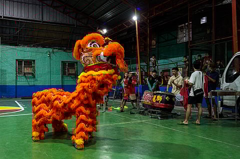 Lion dancers Jhayvee Sicat and Noah King, along with their drummers, practice at a basketball court in downtown Manila on Friday, 6 February 2026. The troupe will be competing for the annual lion dance competition in San Juan City, aiming to defend their title and take home the 50,000-peso cash prize.
