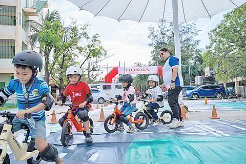 ALONG a mock road course, children practice balance and road awareness during the Kids on Safety activity led by Honda Foundation and Tamang Ride PH.