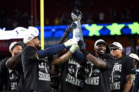 JOSH EDELSON/AGENCE 
THE Seattle Seahawks celebrate with the Vince Lombardi trophy following a 29-13 victory over the New England Patriots in the Super Bowl LX on Sunday at the Levi's Stadium in Santa Clara, California.    