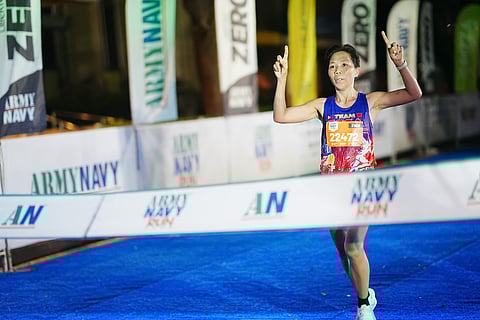MARICAR Camacho celebrates as she crosses the finish line to rule the women’s division of the ArmyNavy Run 2026 in Makati on Sunday.