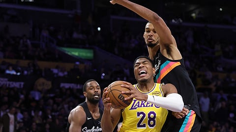 Rui Hachimura #28 of the Los Angeles Lakers controls the ball against Victor Wembanyama #1 of the San Antonio Spurs in the second half at Crypto.com Arena on February 10, 2026 in Los Angeles, California. 