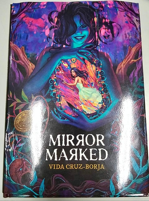 The cover art of MIRROR MARKED, illustrated by Allaine B. Leoncio.