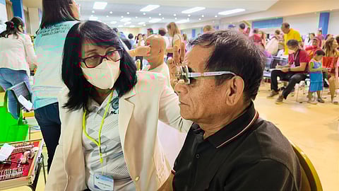 A man gets his eyes checked during the Lab for All Caravan held at the Subic Bay Freeport Zone on 21 May 2024.
