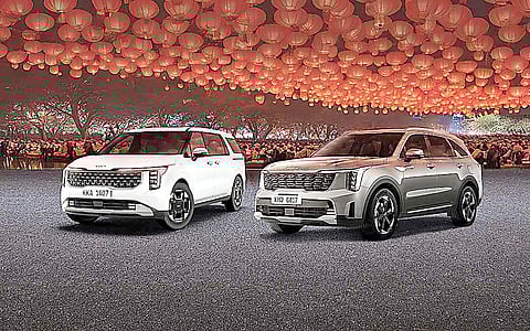 LANTERNS glow behind the Kia Carnival and Sorento during the Lunar New Year-themed display.