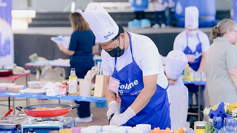 A participant prepares a longganisa-based dish during the Salo-Solane Longganisa Master Cooking Contest at the 2026 Cabanatuan Longganisa Festival.