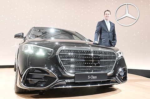 OLA Kaellenius, CEO of Mercedes-Benz Group AG, poses next to a S-class Mercedes-Benz at the company’s Annual Results Conference in Sindelfingen, southern Germany.