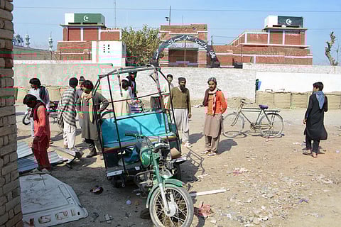 PEOPLE gather at the site of a bomb explosion in Bannu city of Pakistan’s Khyber Pakhtunkhwa province. Two bomb attacks and a gunfight between police and militants in northwest Pakistan killed at least 11 security personnel and three civilians, including a child.