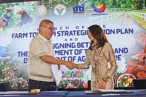 Farm to feast Tourism Secretary Christina Garcia Frasco (right) and Agriculture Secretary Francisco Tiu Laurel Jr. sign a memorandum of agreement on farm, food and gastronomy tourism between the Department of Tourism and the Department of Agriculture, institutionalizing a whole-of-government approach to advancing the Farm Tourism Strategic Action Plan.