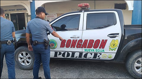 A police officer shows bullet holes on the Bongabon Police vehicle after an armed encounter with robbers in the town of Bongabon, Nueva Ecija on February 17, 2026.