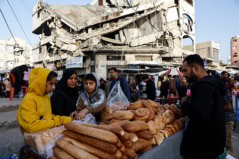 PALESTINIANS sell bread on a street near a destroyed building in Gaza City’s Zawiya market on 18 February 2026, on the first days of the holy fasting month of Ramadan. 