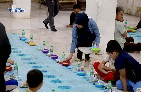 Members of the Salama Community of Barangay Culiat prepare meals for iftar, the first meal taken after a day of fasting during Ramadan, at the Salam Grand Green Mosque in Quezon City on Thursday night, 19 February 2026. | Photo by Analy Labor