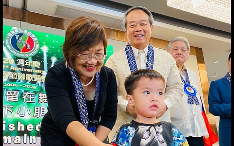 AT TAPh’s 20th, a simple exchange with children and red envelopes captured the quiet continuity of Taiwan’s community life here.