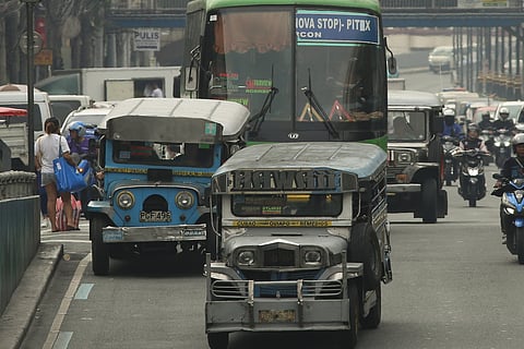 Public utility jeepneys ply their route along Quezon Boulevard. Transport group Pasang Masda is petitioning for a one-peso provisional fare hike following successive oil price increases, while the Land Transportation Franchising and Regulatory Board prepares to conduct public consultations on the proposal.