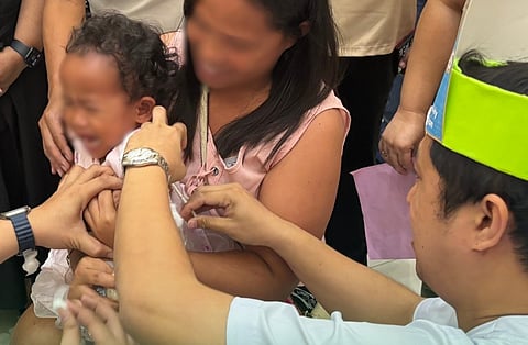 A child receiving an anti-measles vaccine through the Department of Health's Ligtas Tigdas program that was conducted in Tagum, Davao del Norte on 19 January.