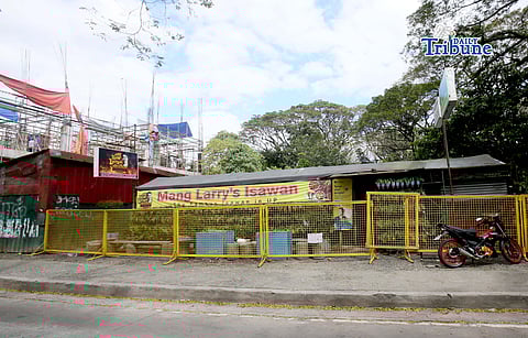 (February 21 2026) Steel barrier seen blocked at the closed main branch of the Mang Larry's Isawan along E. Jacinto Street inside the University of the Philippines Diliman Campus in Quezon City on Saturday. The iconic street food stall has closed down after 50 years following a Quezon City court ordered the closure of the establishment requiring the owner, Laurencio Convencido Jr., to pay P47,500 for "unpaid rental arrears" since October 2021 and "use and occupation of the property" as stated in the civil case won by the university. Photo/Analy Labor