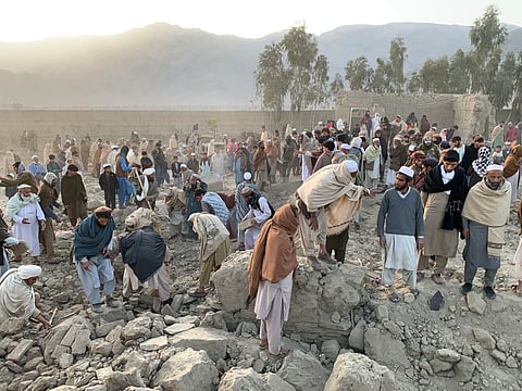AFGHAN men search for victims after an overnight Pakistani air strike hit a residential area in the Girdi Kas village of Bihsud district, Nangarhar province on 22 February 2026.
