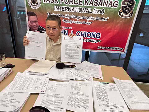 Task Force Kasanag (TFK) founder Dr. John Chiong shows the copies of complaints filed against personalities linked in the anomalous flood control projects. 