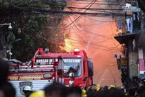 RESIDENTS return to their homes to retrieve their belongings as firefighters continue to extinguish the fire in Brgy 655, Intramuros, Manila on Wednesday, February 25, 2026.