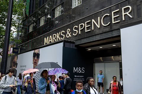 PEDESTRIAN walk past a Marks & Spencer store in London.