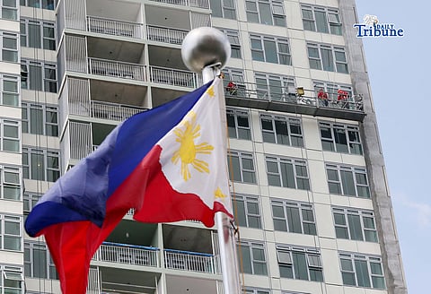 (February 26 2026) Workers hang cleaning the window from the newly built condominium in Quezon City on Thursday, February 26, 2026. The lawmakers from the house of representatives committed to push a national minimum wage system that would abolish provincial wage boards following a meeting with labor groups on Tuesday. Photo/Analy Labor