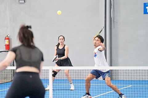 MARK Subtiniente gears up for an attack as teammate Joan Castro looks on during their gold medal showdown against May Mendiola and Christian Mendiola in the Low Intermediate mixed doubles finals of the Pickle Fest 2026 Adult Categories Sectional Tournament in Davao City.