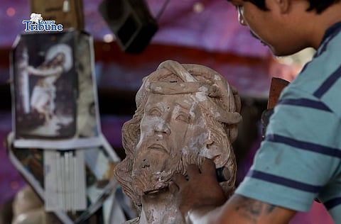 AS the Lenten season begins on Ash Wednesday, a wood sculpture artist is seen carving an image of Jesus Christ from salvaged wood in Iloilo City on Saturday, 28 February 2026.