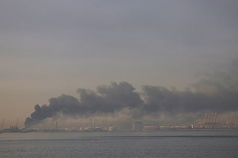 A plume of smoke rises from the port of Jebel Ali following a reported Iranian strike in Dubai on March 1, 2026. Fresh blasts were heard across the Gulf cities of Dubai, Doha and Manama on Sunday morning after a day of Iran strikes in the region in retaliation for US and Israeli attacks.