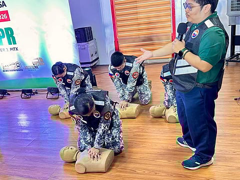 TRANSPORT workers practice CPR on dummies. 