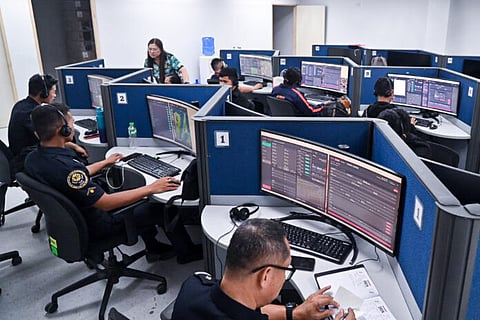 MEMBERS of the Philippine National Police man the Unified 911 system as they wait for callers. The PNP also announced that it is planning to add more female police officers to handle reports of domestic violence.