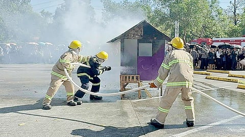 FIREFIGHTERS put out a simulated blaze in a mock structure during a fire and earthquake drill at SM City Dasmariñas, demonstrating coordinated response and suppression techniques before mall tenants, employees and students.