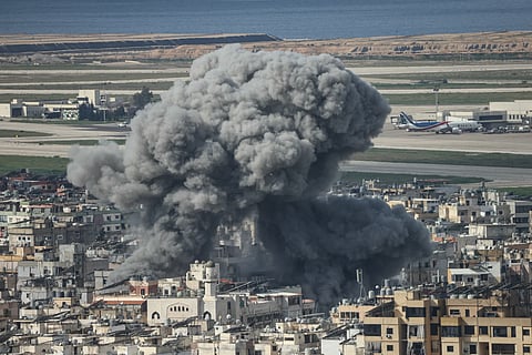 Smoke rises from the site of an Israeli airstrike that targeted the Al Lailaki neighbourhood in Beirut’s southern suburbs, with the city's International Airport visible in the background, on March 4, 2026. Israel launched fresh strikes on Iran and Lebanon, where state media reported a residential building was hit on March 4, as Iran's Guards said they had sealed off one of the world's most vital shipping routes for energy.