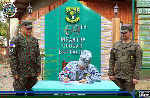 NOLCOM Commander Lt. Gen. Aristotle D. Gonzalez, PAF, signs the guest logbook at the headquarters of the 69th Infantry Battalion (69IB), Philippine Army, in Brgy. Bulawen, Palauig, Zambales, on 3 March 2026. 69IB chief Lt. Col. Mark Anthony B. Ruelos and 69IB Battalion Executive Officer Maj. Marian Victor E. Mancia, INF, assist Gonzalez during his visit.