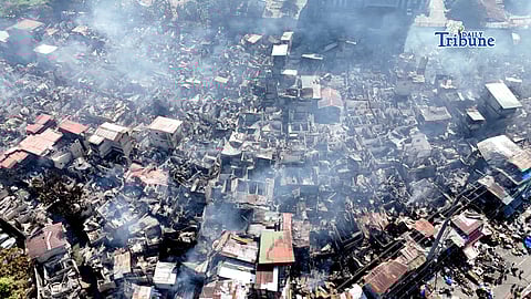 RESIDENTS sift through the charred remains of their homes, salvaging what little can still be reused after a massive fire gutted about 95 percent of a residential area in Barangay Pinyahan, Quezon City on Saturday.