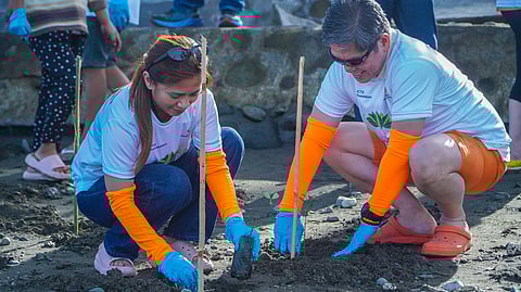 GABRIEL Muñasque (right), general manager of South Cotabato Integrated Port Services Inc., and Rejamna Jubelag, SCIPSI HR manager, join the mangrove planting in Barangay Tuyan, Malapatan, Sarangani. 
