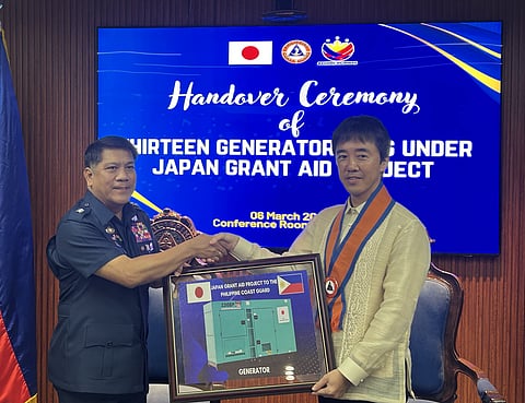 RADM Rommel A. Supangan of the Philippine Coast Guard (left) and Minister for Economic Affairs YOKOTA Naobumi (right) shake hands during the turnover of generators with trailers provided by Japan through Official Development Assistance to support PCG operations.