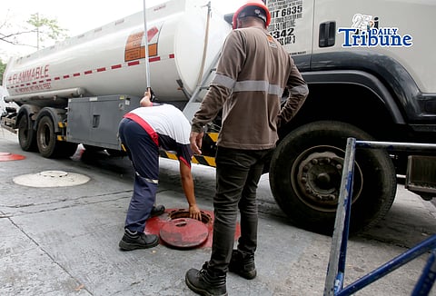 (March 11 2026) Gas attendants measure the fuel  supply in their tanks at a gasoline station along East Avenue in Quezon City on Tuesday March 10 2026, following the hike in prices by oil companies due to the on-going conflict in the Middle East. Photo/Analy Labor