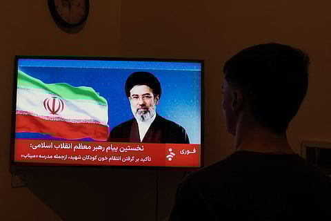 A man watches a televised statement by Iran's new supreme leader Mojtaba Khamenei on March 12, 2026. Iran's new supreme leader ordered the vital Strait of Hormuz oil shipping lane to remain closed on March 12, while US President Donald Trump said stopping the Islamic republic's "evil empire" was more important than crude prices. Ayatollah Mojtaba Khamenei, who was reportedly injured in an air strike, has yet to appear publicly since his nomination as supreme leader, and his defiant message was read by a newscaster on state television.
