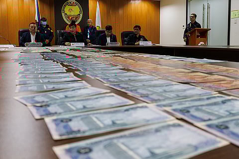 National Bureau of Investigation Director Atty. Melvin Matibag and Bangko Sentral ng Pilipinas representative Atty. Mark Fajardo inspect the alleged counterfeit foreign banknotes and U.S. Treasury bills seized in a buy-bust operation during a press conference in Pasay City on Friday, 13 March 2026.

The suspect was arrested after a three-month investigation by the NBI Criminal Intelligence Division, with authorities recovering alleged fake U.S. dollar banknotes and other foreign currencies valued at about 12 billion pesos.

“Sa Amerika, ayan po ay accepted. Dito sa atin, hindi. I don’t know why?” the suspect said.